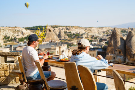 Family of father and daughter having breakfast outdoors in Cappadocia Turkeyの写真素材