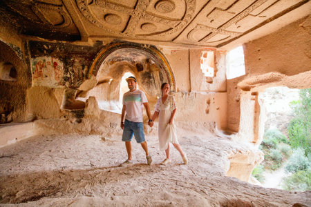 Young couple touring cave church of Three Crosses in Rose Valley in Cappadocia Turkey dated back to 10th centuryの写真素材