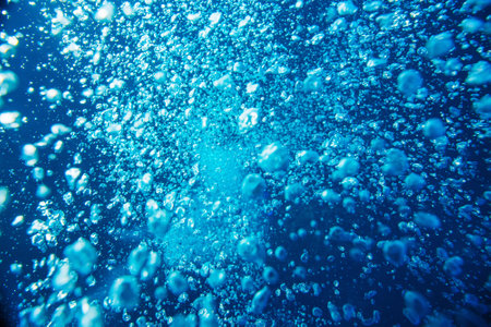 Blue ocean water with diving bubbles close up backgroundの写真素材