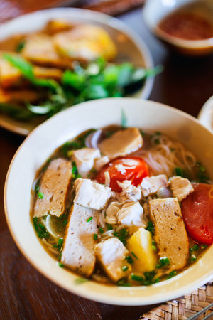 Fresh rice noodle soup with fish central Vietnam dishの写真素材