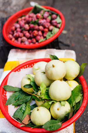 Assortment of fresh wax apples and other fruits on market stall in Hanoi Vietnam
