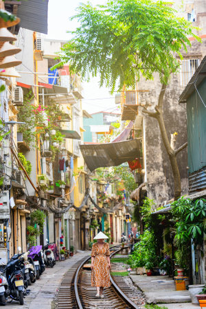 Beautiful woman walking along railway tracks in Hanoi Vietnamの写真素材
