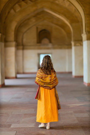 Beautiful woman enjoying vacation in India visiting Sikandra Akbar tomb attraction in Agraの写真素材