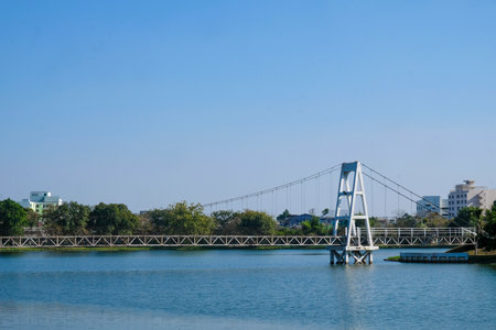 Suspension bridge over the river with blue sky background, Thailand.の写真素材