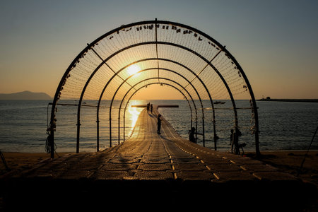 Silhouette of people on the beach at sunset time.の写真素材