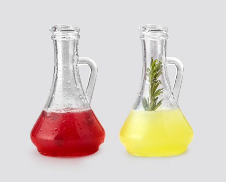 Two glass decanters with red and yellow juice lemonadeの写真素材