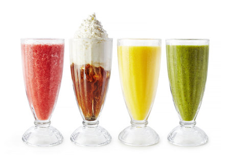 Different smoothies in glasses on white background closeupの写真素材