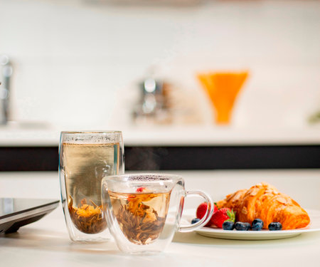 Double wall glass cups with tea on tableの写真素材