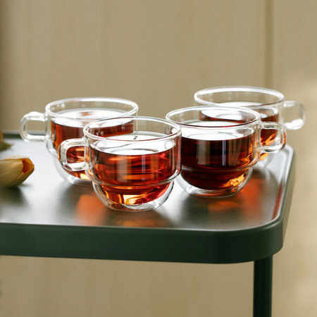 Set of double wall glass cups with black tea on the tableの写真素材