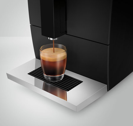 Home coffee machine makes Americano in a glass cup, close upの写真素材