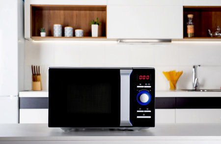 Modern black microwave oven on kitchen countertopの写真素材
