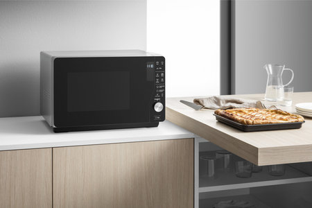 Modern black microwave oven in the kitchenの写真素材