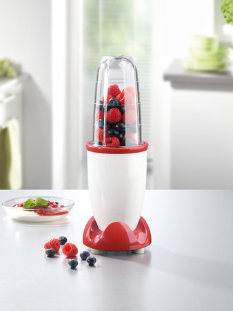 Mini hand mixer with fruits on white kitchen tableの写真素材