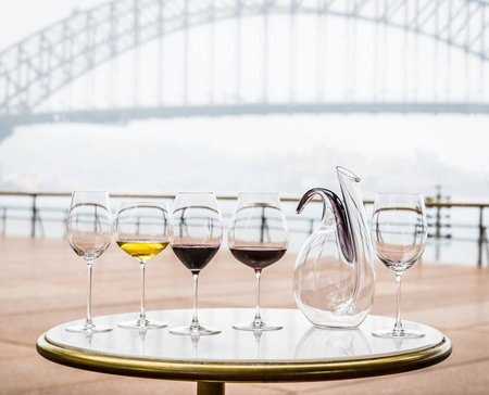 Wine decanter with wine glasses on tableの写真素材