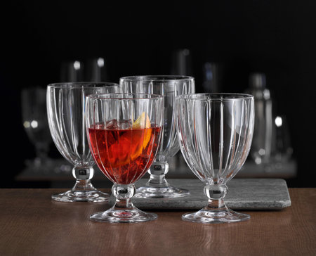 Alcoholic drink with ice in transparent glasses on a wooden tableの写真素材