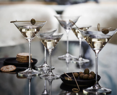 Martini glasses with olives on a tableの写真素材