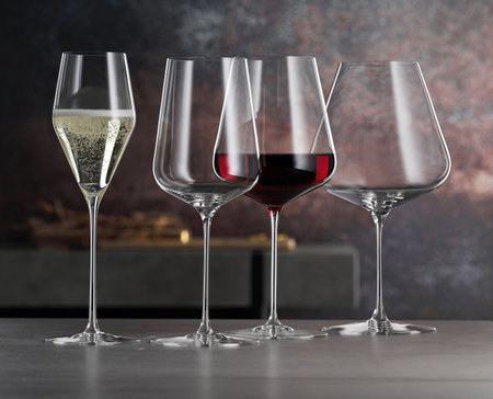 Set of wine glasses and champagne glasses on a tableの写真素材