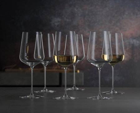 Set of white wine glasses on a tableの写真素材