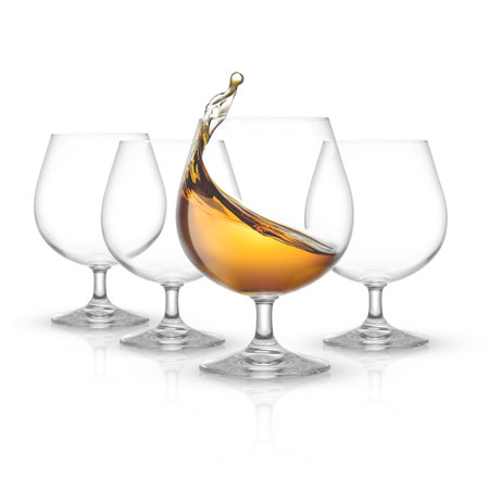 glass of whiskey with splashes isolated on a white backgroundの写真素材