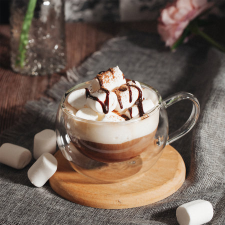 Double wall glass coffee cup with marshmallowの写真素材