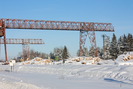 Platform covered with snow for wood unloading near to a sawmillの写真素材