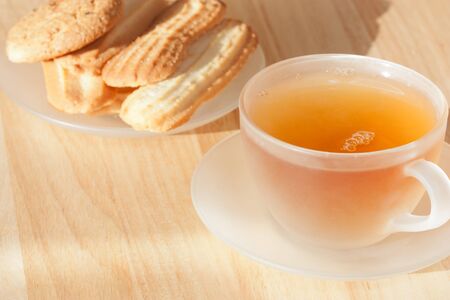 Cup of tea on a wooden table with bakingの写真素材