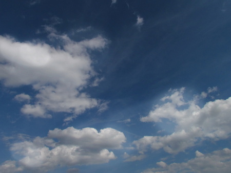 Beautiful white clouds on dark blue summer sky.の写真素材