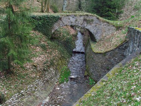 forest still life with stone bridge over stream near castle Cesky Sternberk, Central Bohemia regionの写真素材