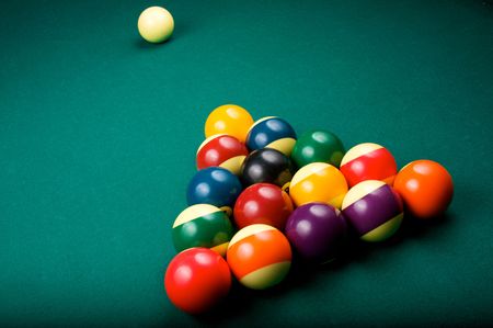 Billiard balls are racked in a triangle, waiting to be broken by the cue ball. Shallow depth of field.の写真素材