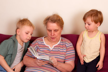 grandmother and her grandsons read the bookの写真素材