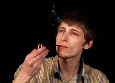 young man smoking tobacco pipeの写真素材