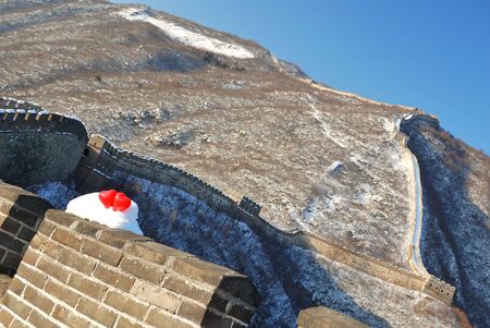 two red balloon in the form of a heart on Great wall in snowの写真素材