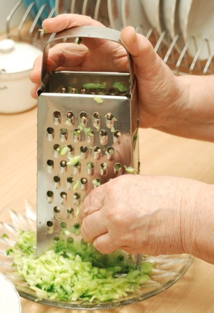 elderly woman grate cucumberの写真素材