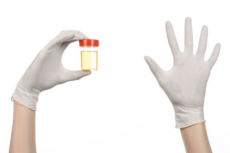 Medical theme: doctor's hand in white gloves holding a transpareの写真素材