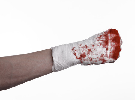 shook his bloody hand in a bandage, bloody bandage, fight club, street fight, violence, bloody theme, black background, isolated, bloody fists, boxer, tied his hands with a bandage, white background studioの写真素材