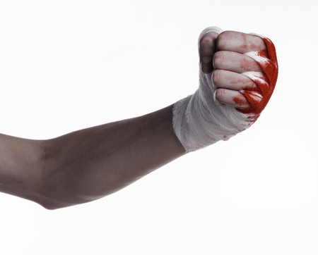 shook his bloody hand in a bandage, bloody bandage, fight club, street fight, violence, bloody theme, black background, isolated, bloody fists, boxer, tied his hands with a bandage, white background studioの写真素材
