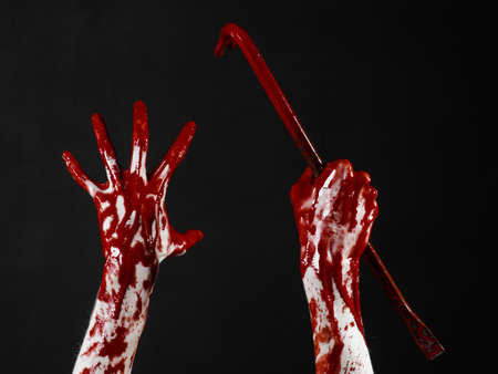 Bloody hands with a crowbar, hand hook, halloween theme, killer zombies, black background, isolated, bloody crowbar studioの写真素材