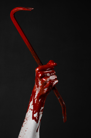Bloody hands with a crowbar, hand hook, halloween theme, killer zombies, black background, isolated, bloody crowbar studioの写真素材