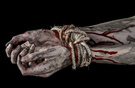 Hands bound,bloody hands, mud, rope, on a black background, isolated, kidnapping, zombie, demon studioの写真素材