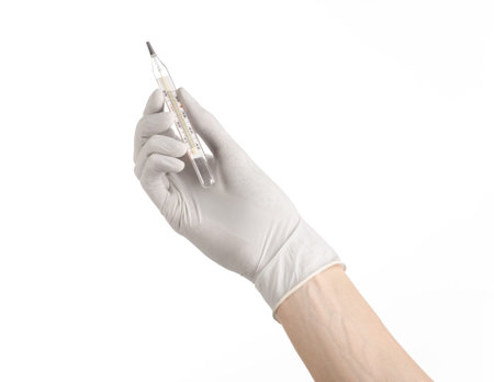 Medical theme: doctor's hand in white gloves holding a thermometer to measure the temperature of the...