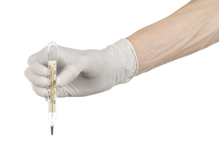 Medical theme: doctor's hand in white gloves holding a thermometer to measure the temperature of the...