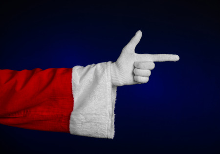 Santa Claus theme: Santa's hand showing gesture on a dark blue background studioの写真素材