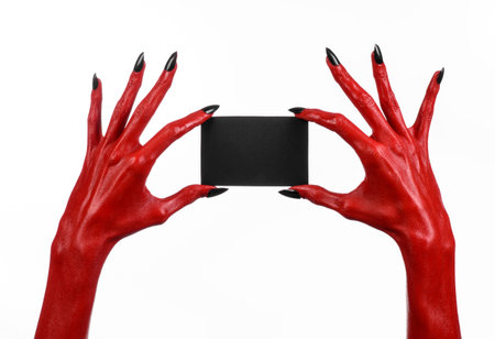 Halloween theme: Red devil hand with black nails holding a blank black card on a white background...