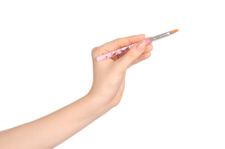 Beauty and makeup topic: a woman's hand holding a brush makeup isolated on white backgroundの写真素材
