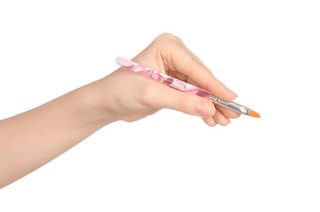 Beauty and makeup topic: a woman's hand holding a brush makeup isolated on white backgroundの写真素材