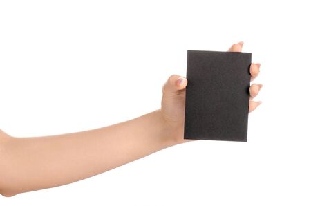 Branding and advertising theme: beautiful female hand holding empty black paper card isolated on white background studioの写真素材