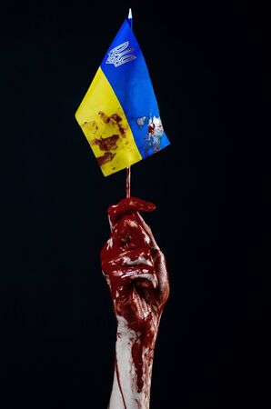 Bloody hands, the flag of Ukraine in the blood, revolution in Ukraine, Black backgroundの写真素材