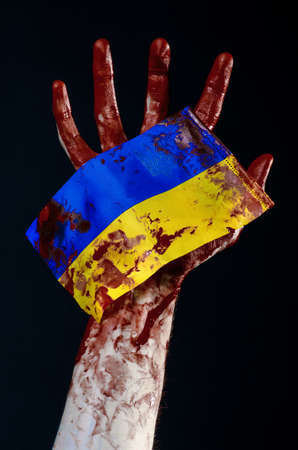 Bloody hands, the flag of Ukraine in the blood, revolution in Ukraine, Black backgroundの写真素材