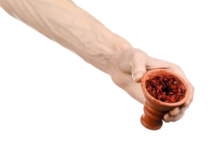 Hookah topic: Bartender holding a clay bowl with tobacco for hookah isolated on white background