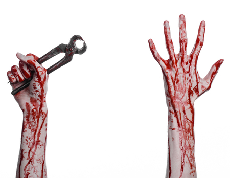 Halloween theme: bloody hand holding a pliers on a white background studioの写真素材